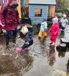 FCSS - child playing outside in the puddles