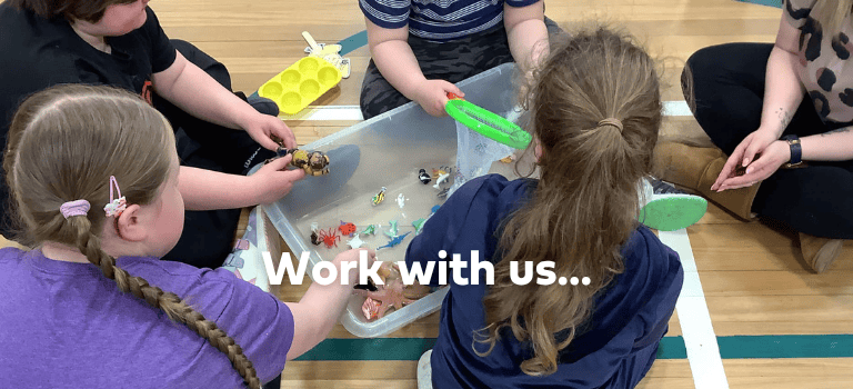 FCSS Job advert. Children in a circle playing with a container of toys