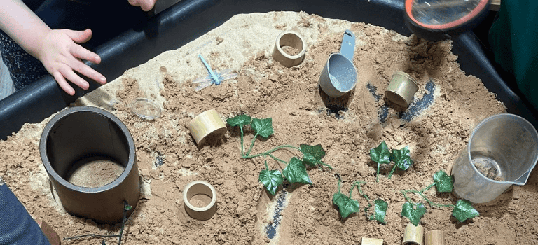 FCSS Case Study. Photo of child playing in sand sensory tray