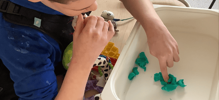 FCSS ASN Groups, child playing in sensory tray